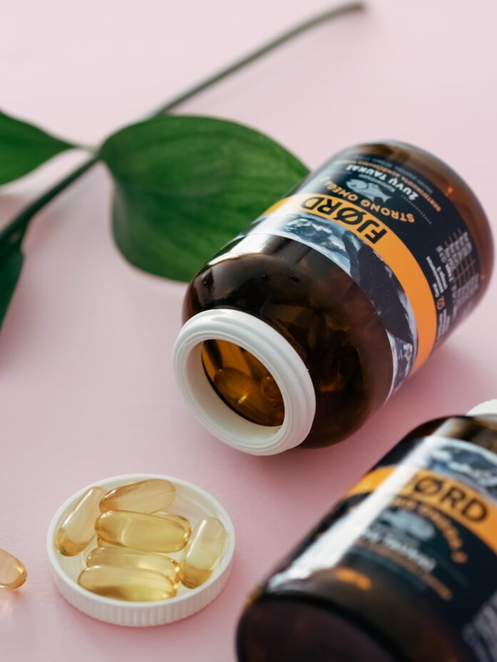 a close up of a bottle of pills next to a plant